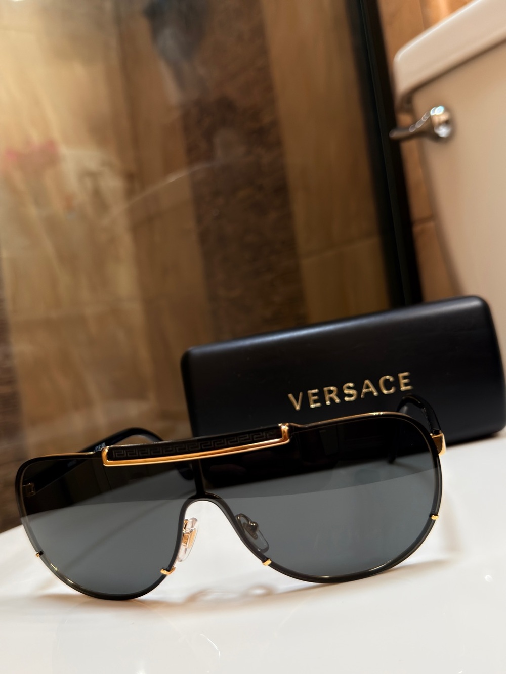 Versace MENS WOMENS Unisex Gold and Black Shield Sunglasses
VE2140